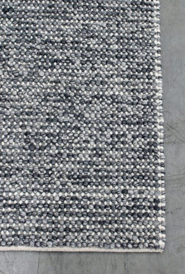 Magic Storm two tone greys and ivory blend handmade wool rug. knotted loops of wool adding texture finish